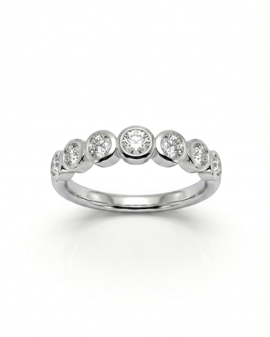 White gold half eternity ring with seven bezel-set round diamonds.