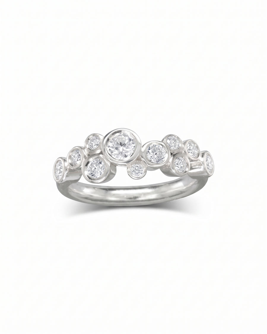Silver half eternity ring with bezel-set round diamonds in a bubble design.