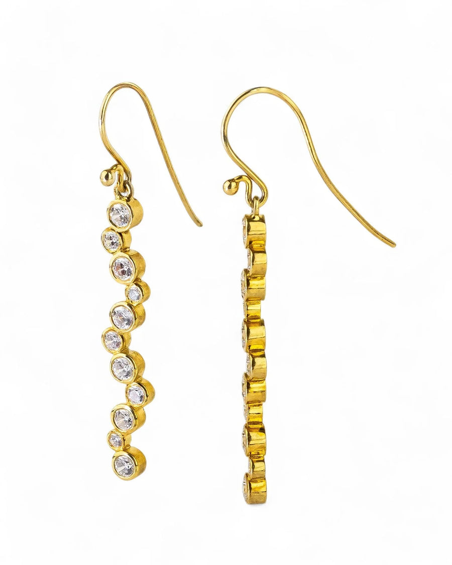 Gold drop earrings with a wavy line of round diamonds.
