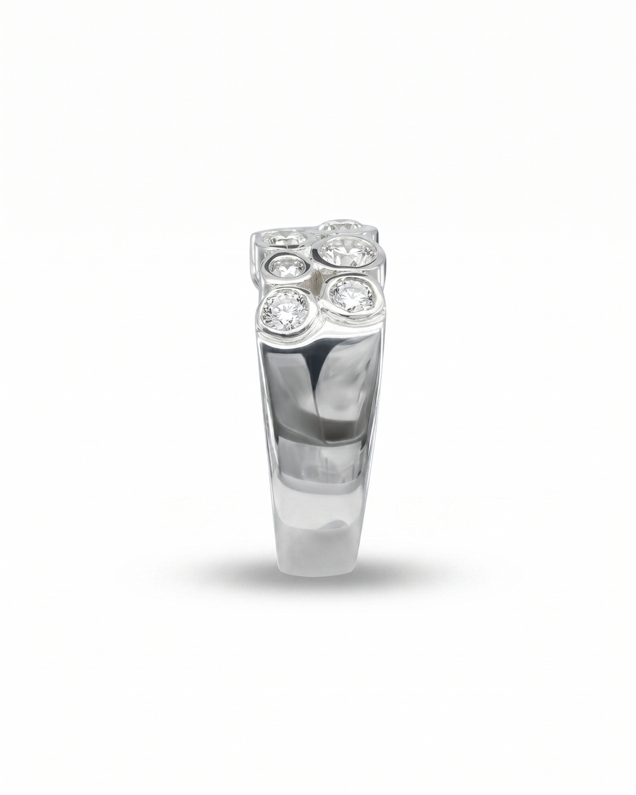 Platinum eternity ring with bezel-set round diamonds in a bubble design.
