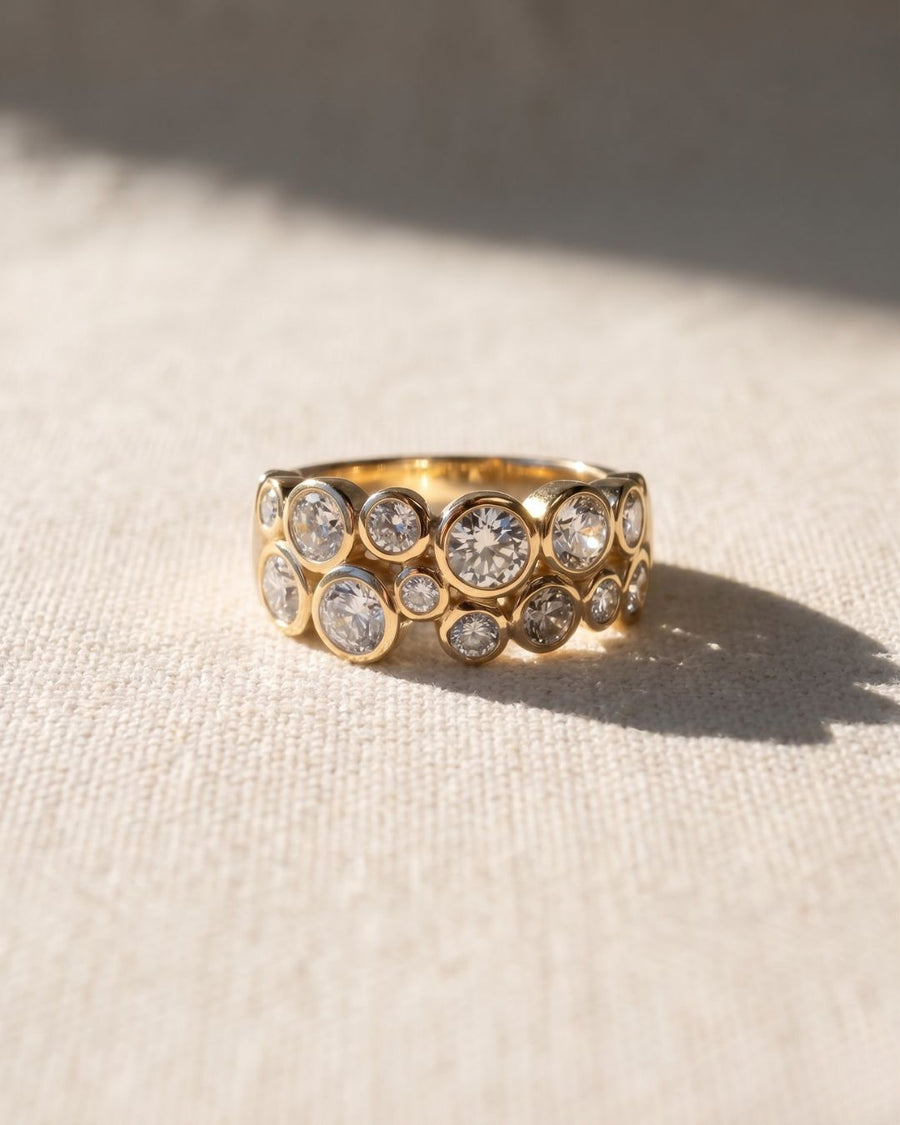 9ct yellow gold eternity ring with bezel-set round diamonds in a bubble design.