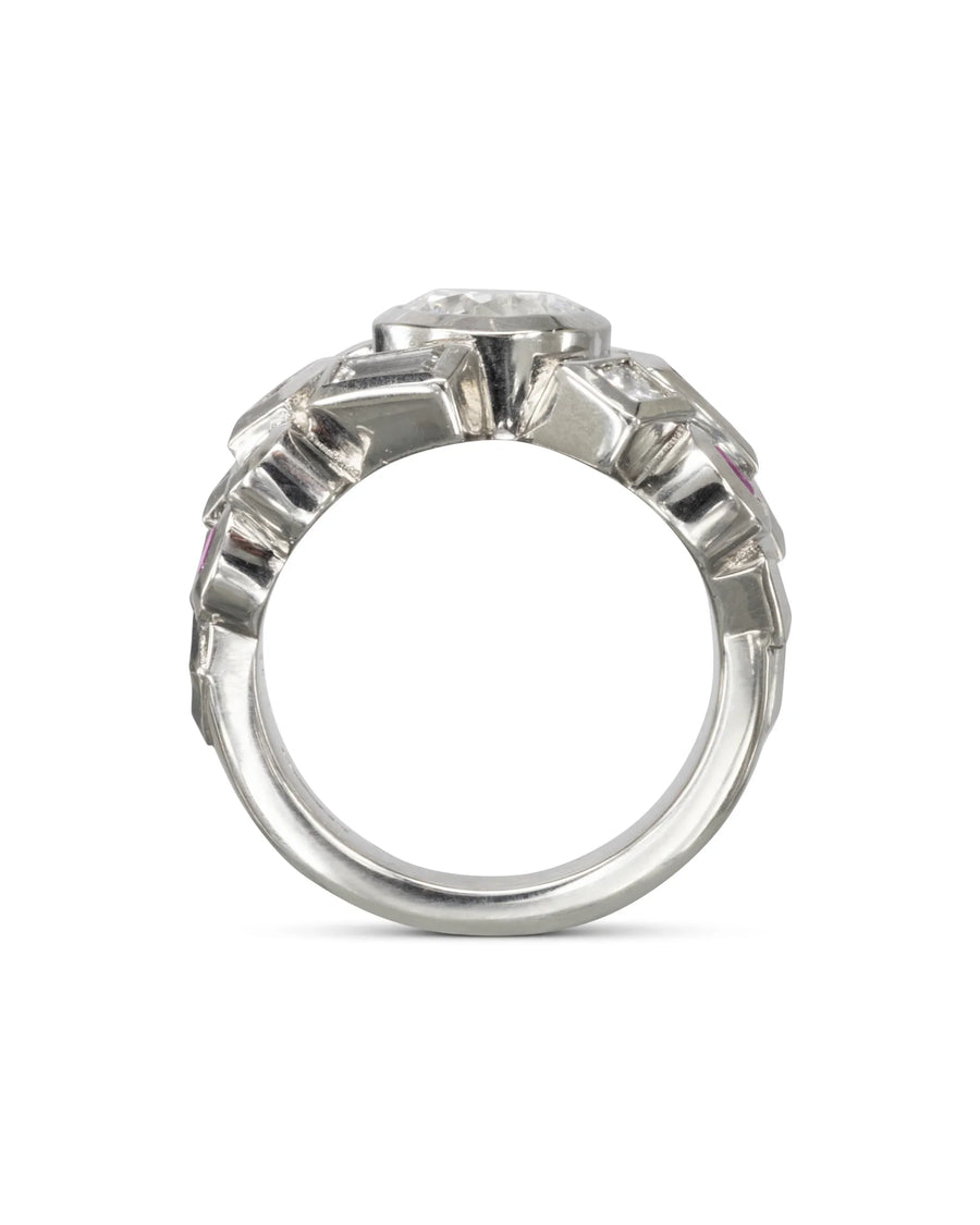 Handmade silver ring with a prominent central gemstone and textured organic design