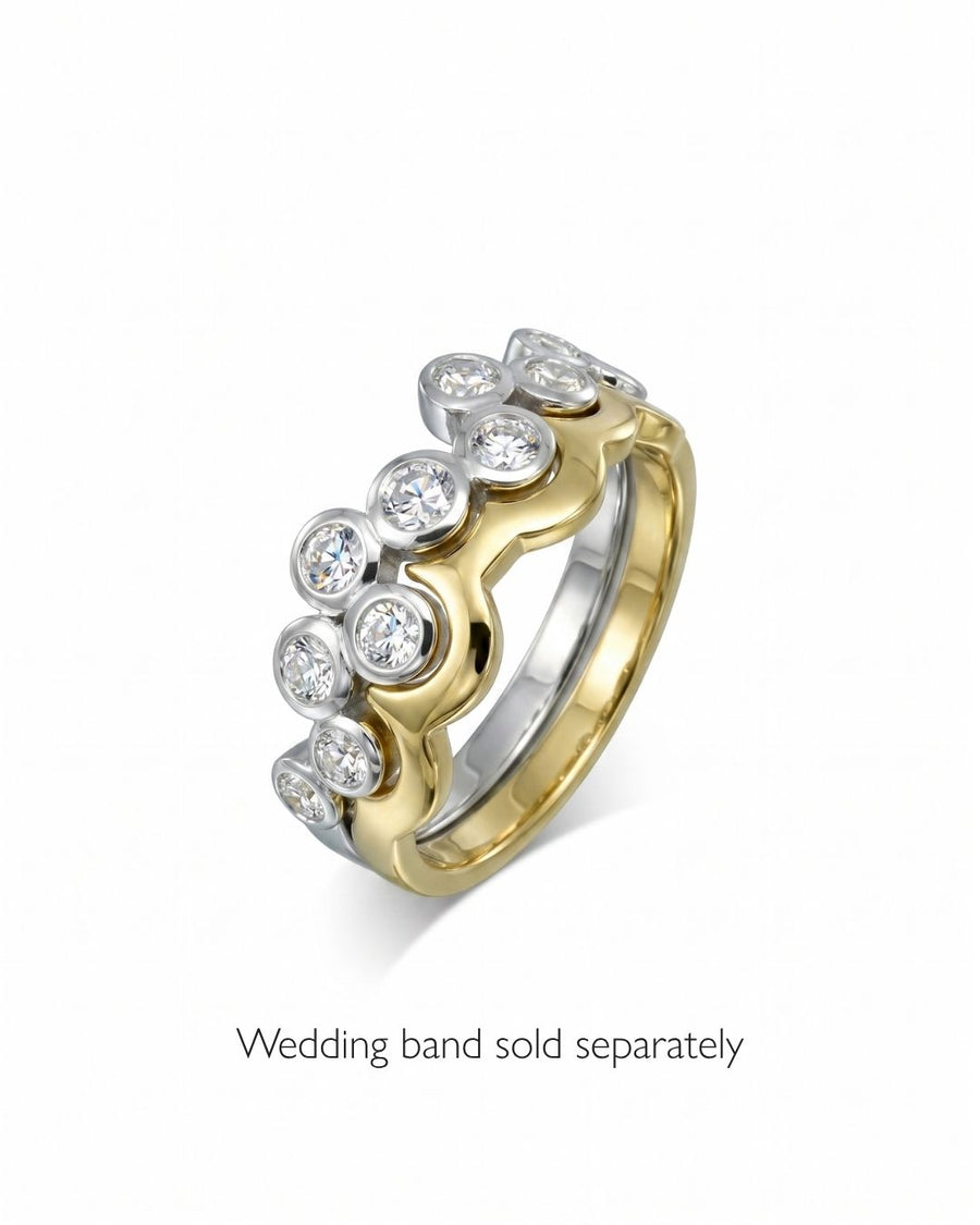Gold and white gold half eternity ring with large round diamonds.
