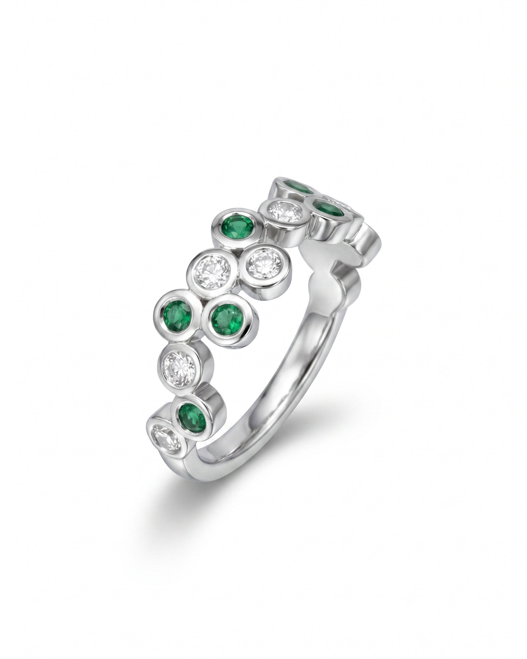 Silver half eternity ring with round emeralds and diamonds in bubble settings.
