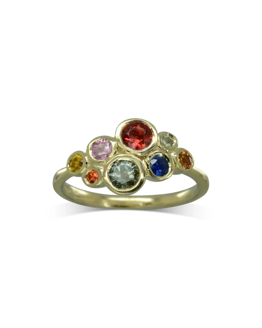 Gold ring with a cluster of multi-coloured sapphire gemstones.