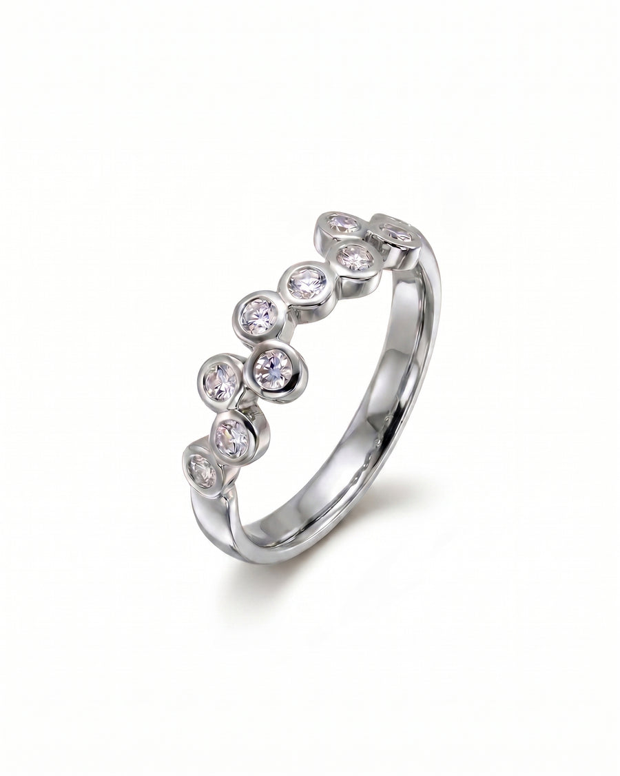 9ct white gold eternity ring with offset round diamonds.