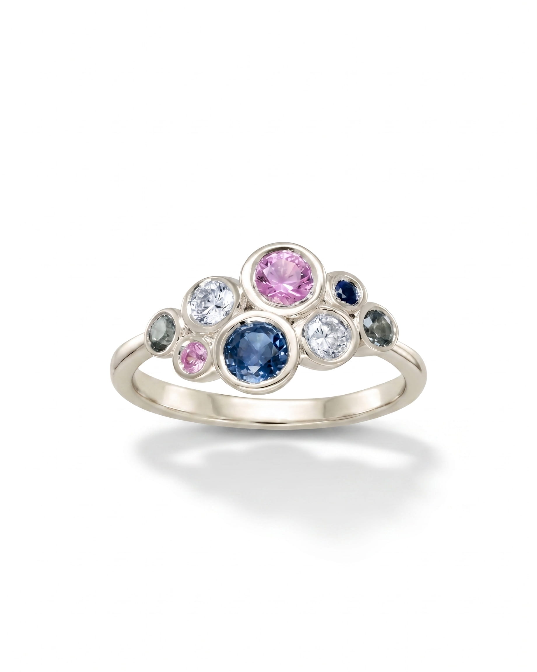 White gold ring with pink, teal, and blue sapphire cluster.