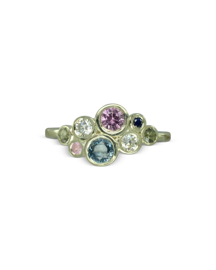 Silver ring with pink, teal, and clear sapphire cluster.