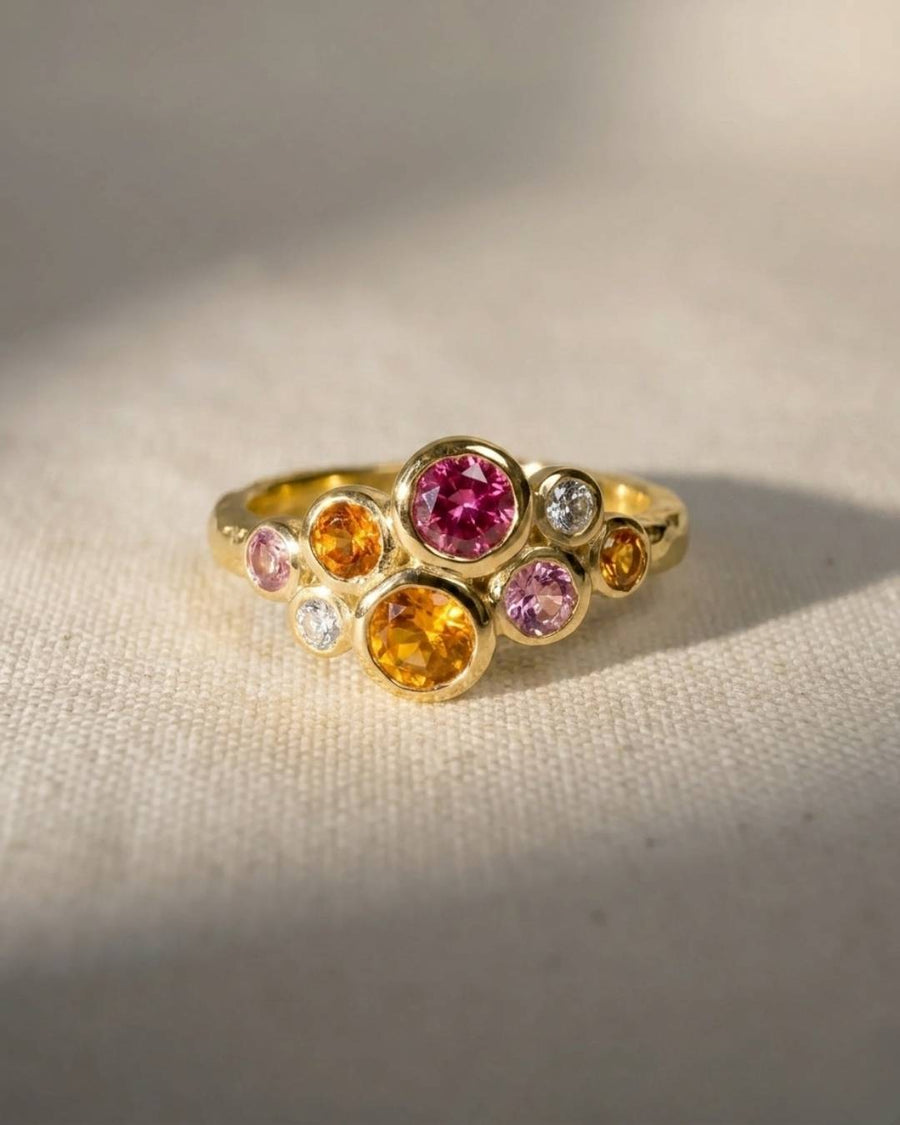 Gold cluster ring with pink tourmaline, citrine, and diamond gemstones.