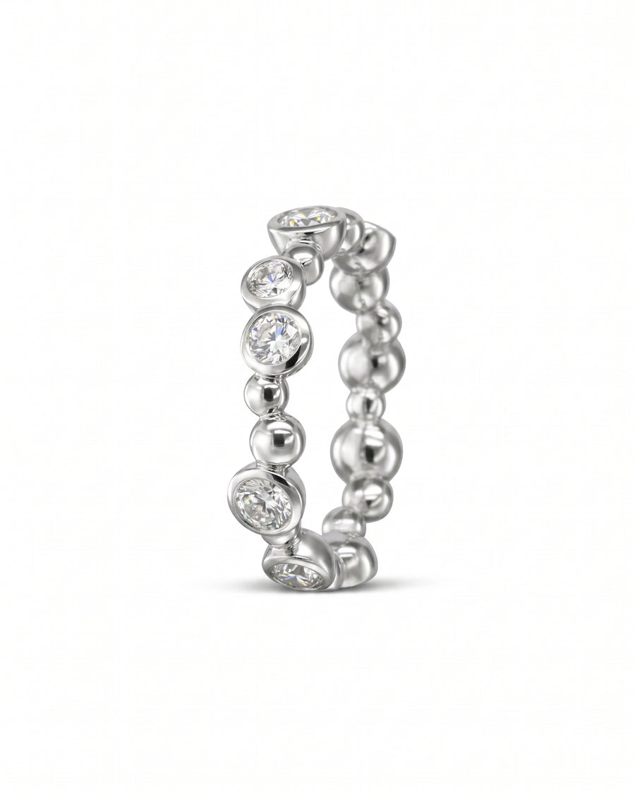 Silver eternity ring with random diamond and bubble design.
