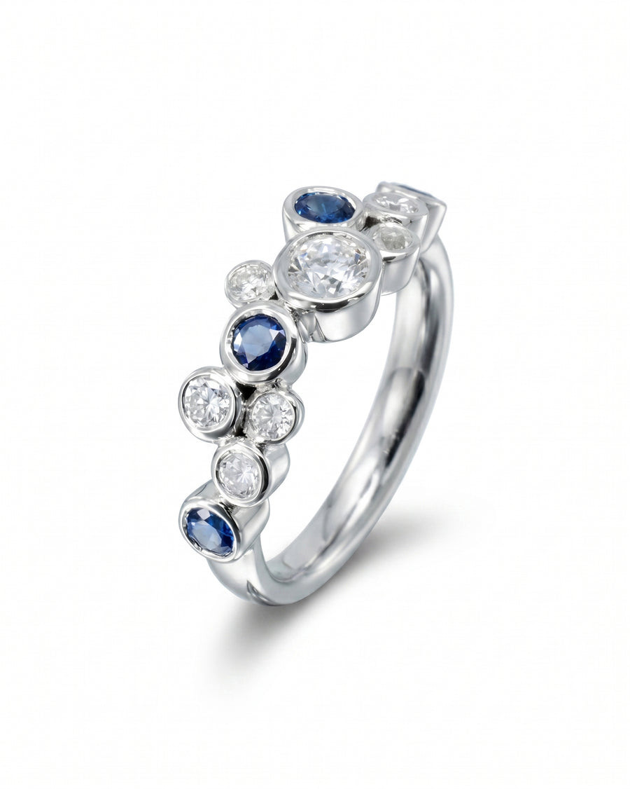 White gold eternity ring with random sapphire and diamond bubbles.