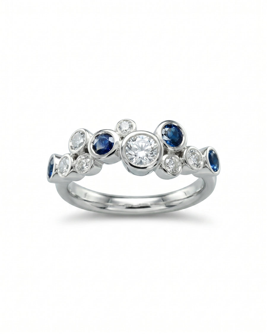 White gold eternity ring with random sapphire and diamond bubbles.