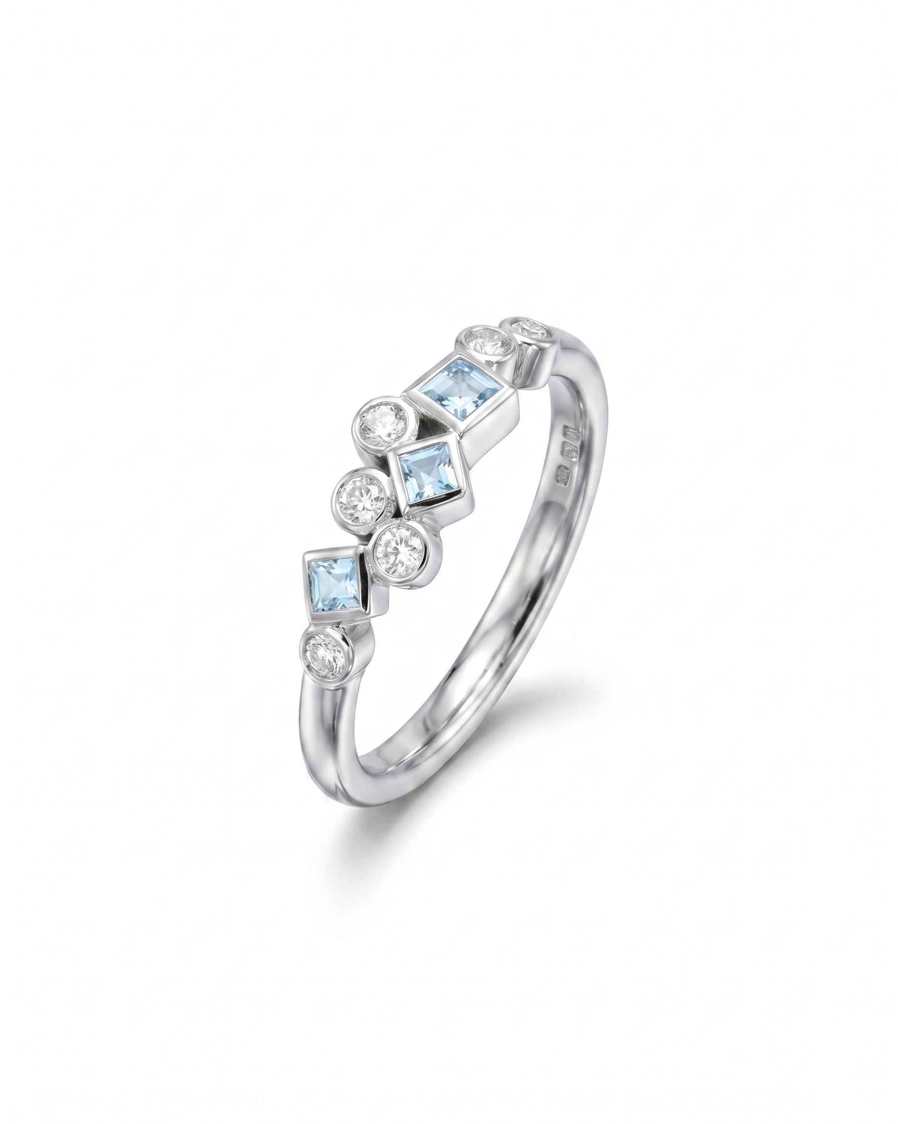 Silver half eternity ring with aquamarine and diamond gemstones.