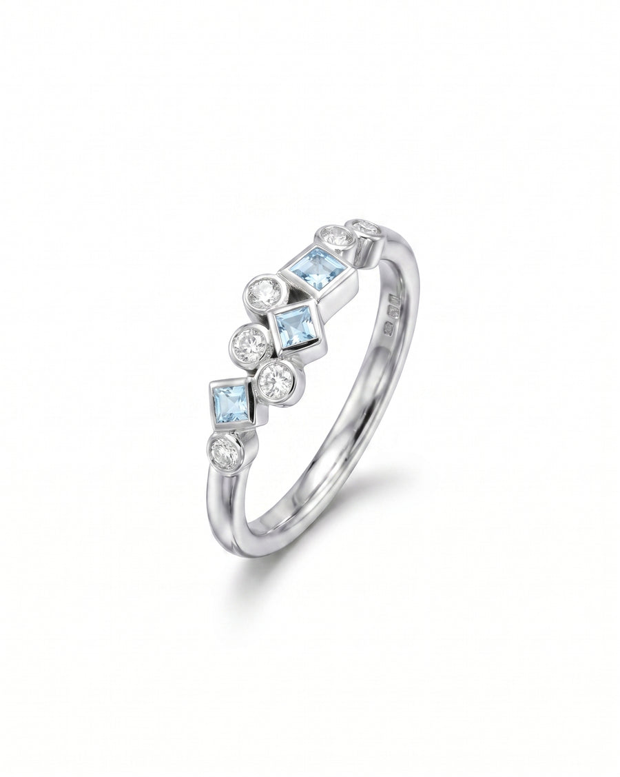 Silver half eternity ring with aquamarine and diamond gemstones.