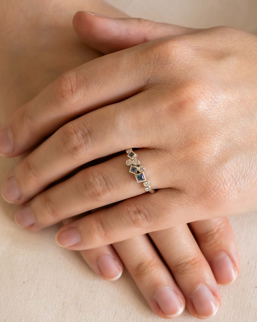 Gold half eternity ring with aquamarine and diamond gemstones.