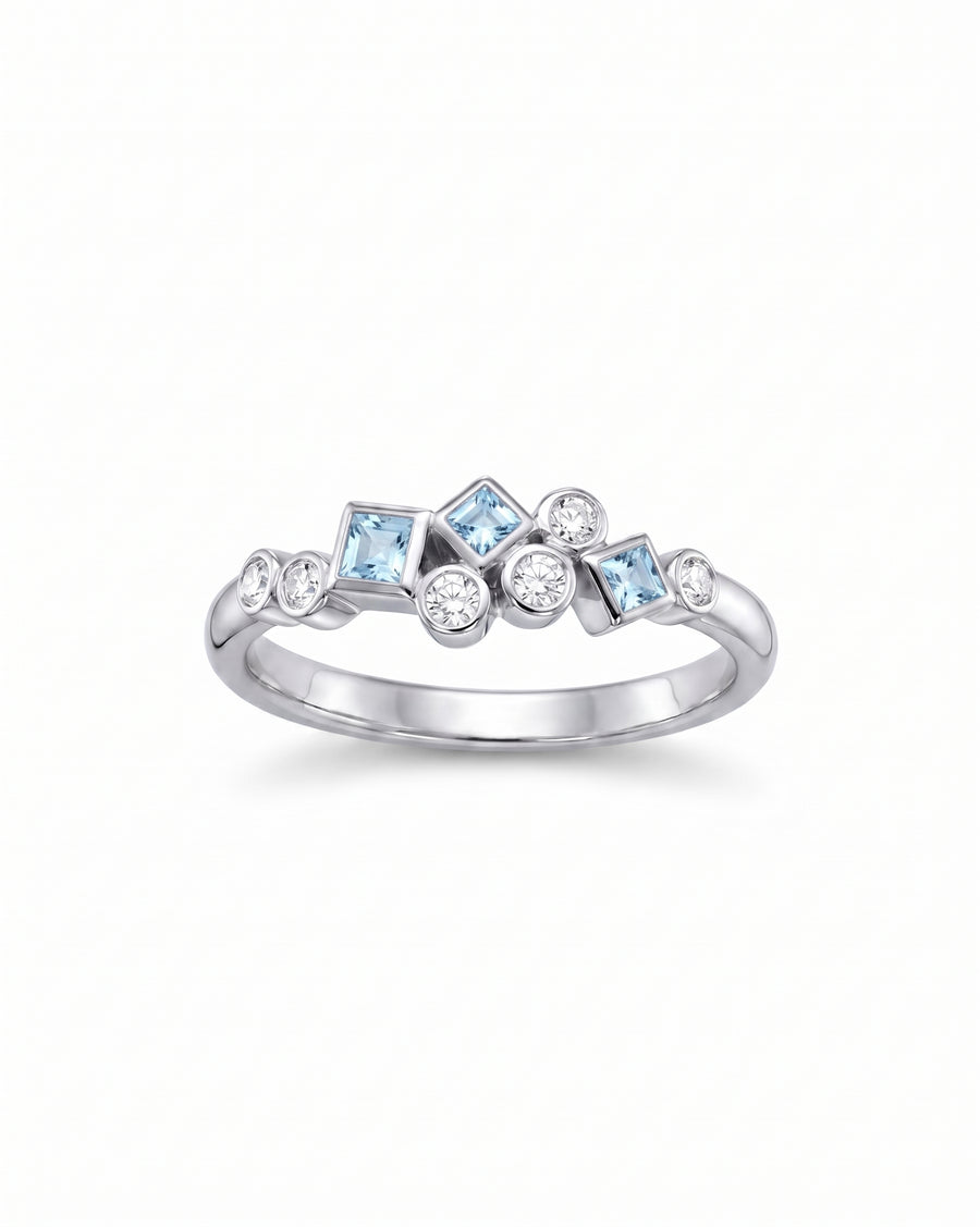 White gold half eternity ring with aquamarine and diamond gemstones.