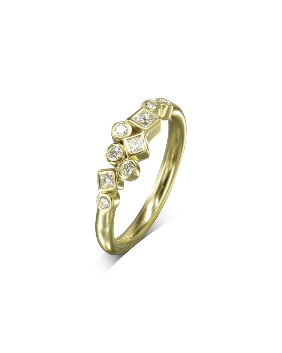 Gold ring with scattered round and square diamonds.