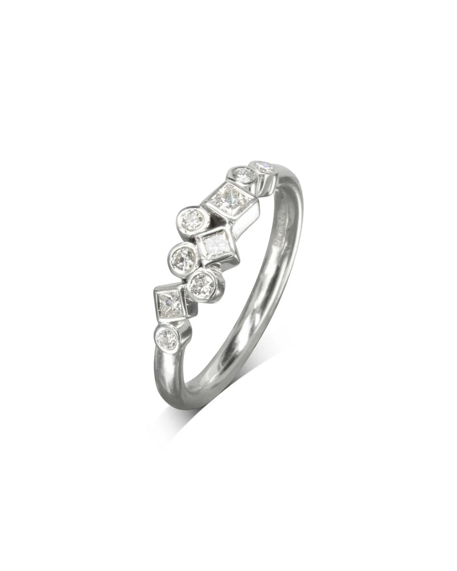 Platinum ring with round and square diamonds in a scattered design.