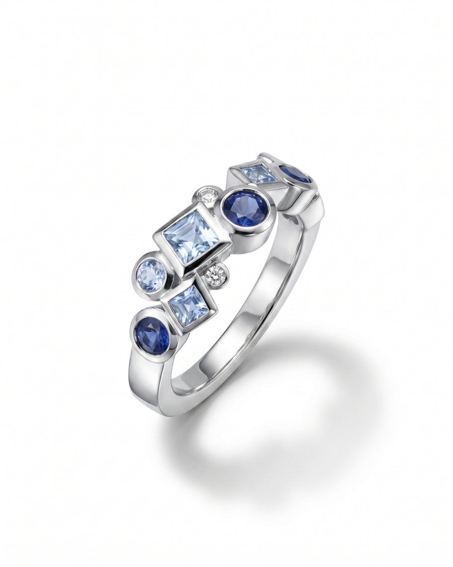 9ct white gold half eternity ring with blue sapphires and diamonds in various shapes.