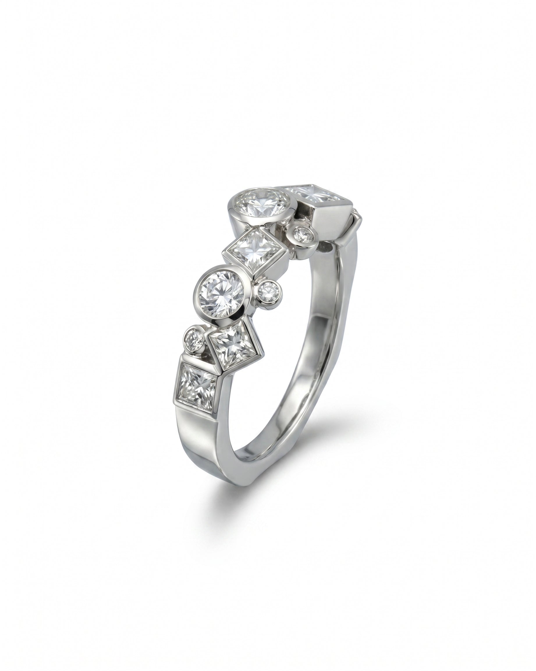 Silver ring with round and square cut diamonds in a unique, scattered design.