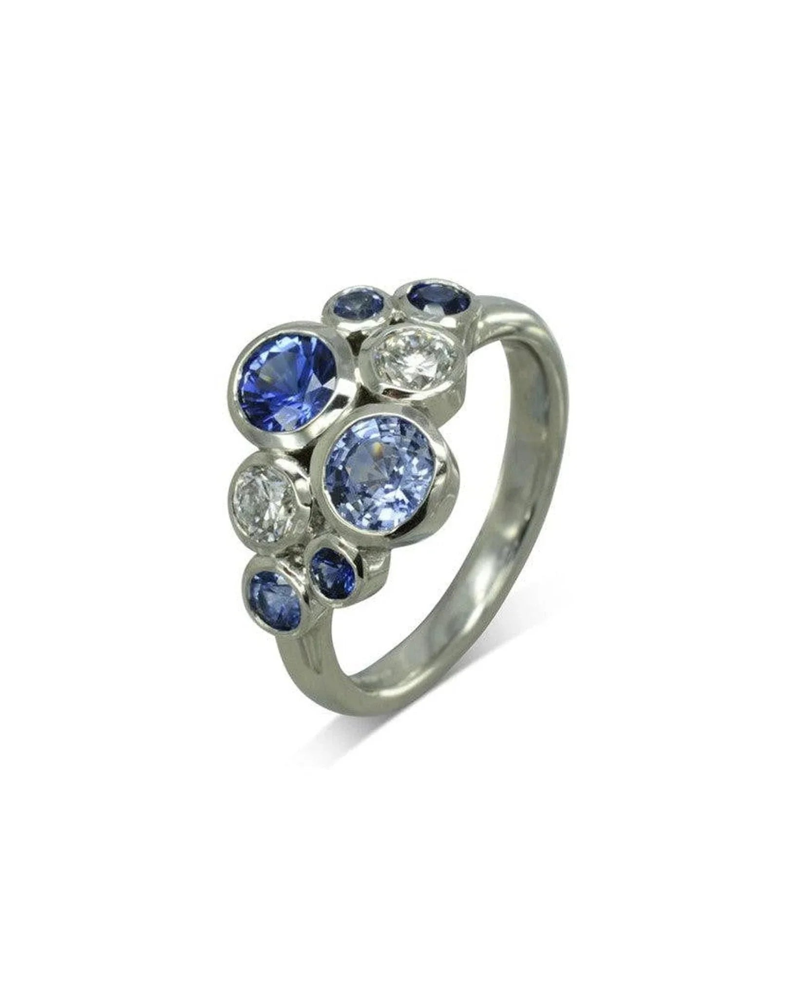 Platinum ring with cluster of round blue sapphires and diamonds in organic setting