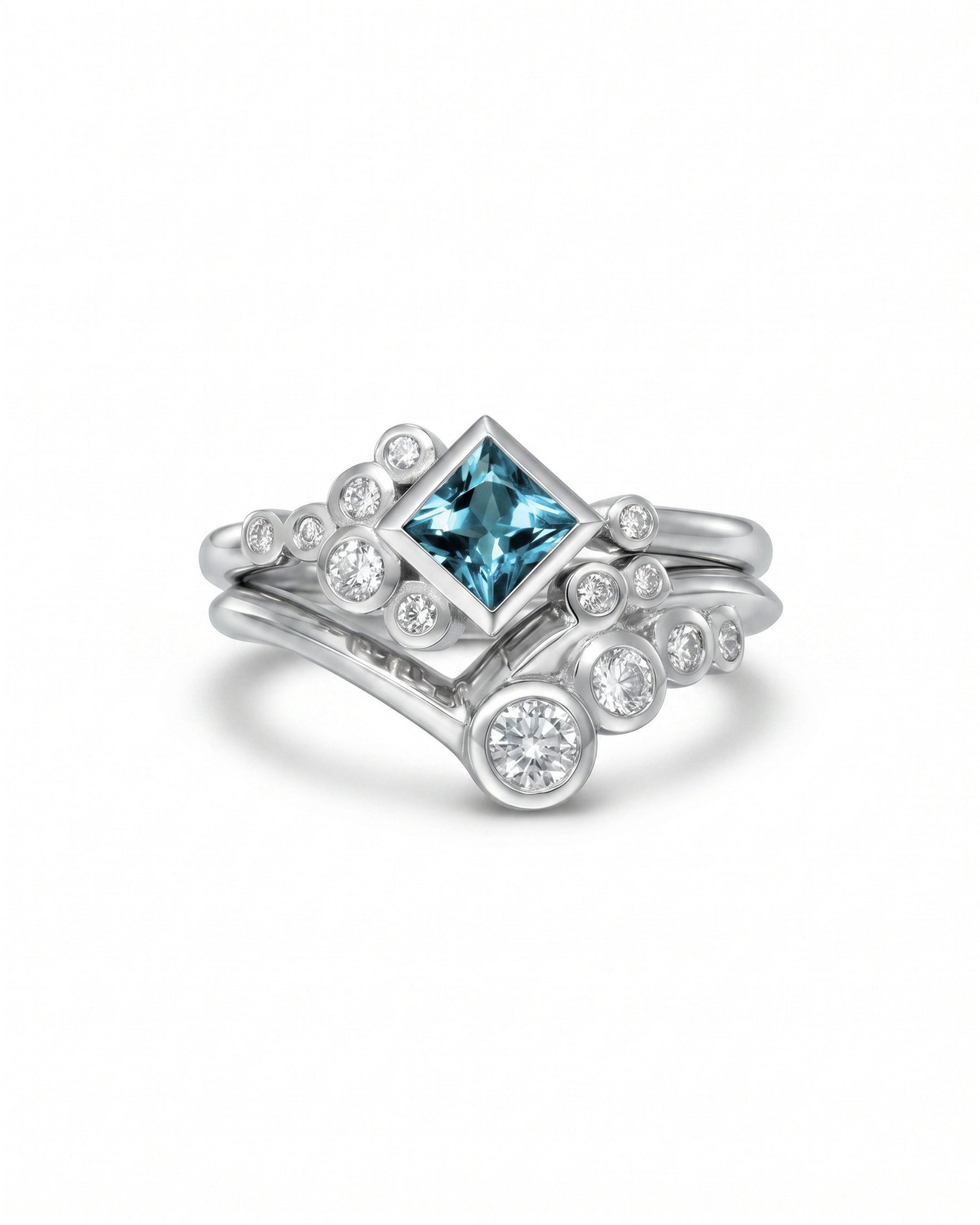 Silver ring set with a square aquamarine and round diamonds in a bubble design.