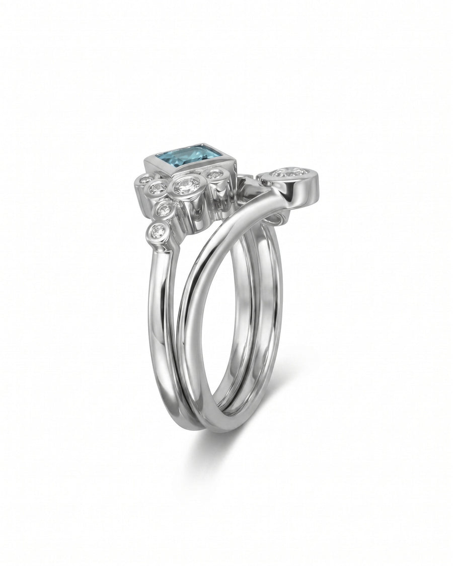 Silver ring set with a square aquamarine and round diamonds.
