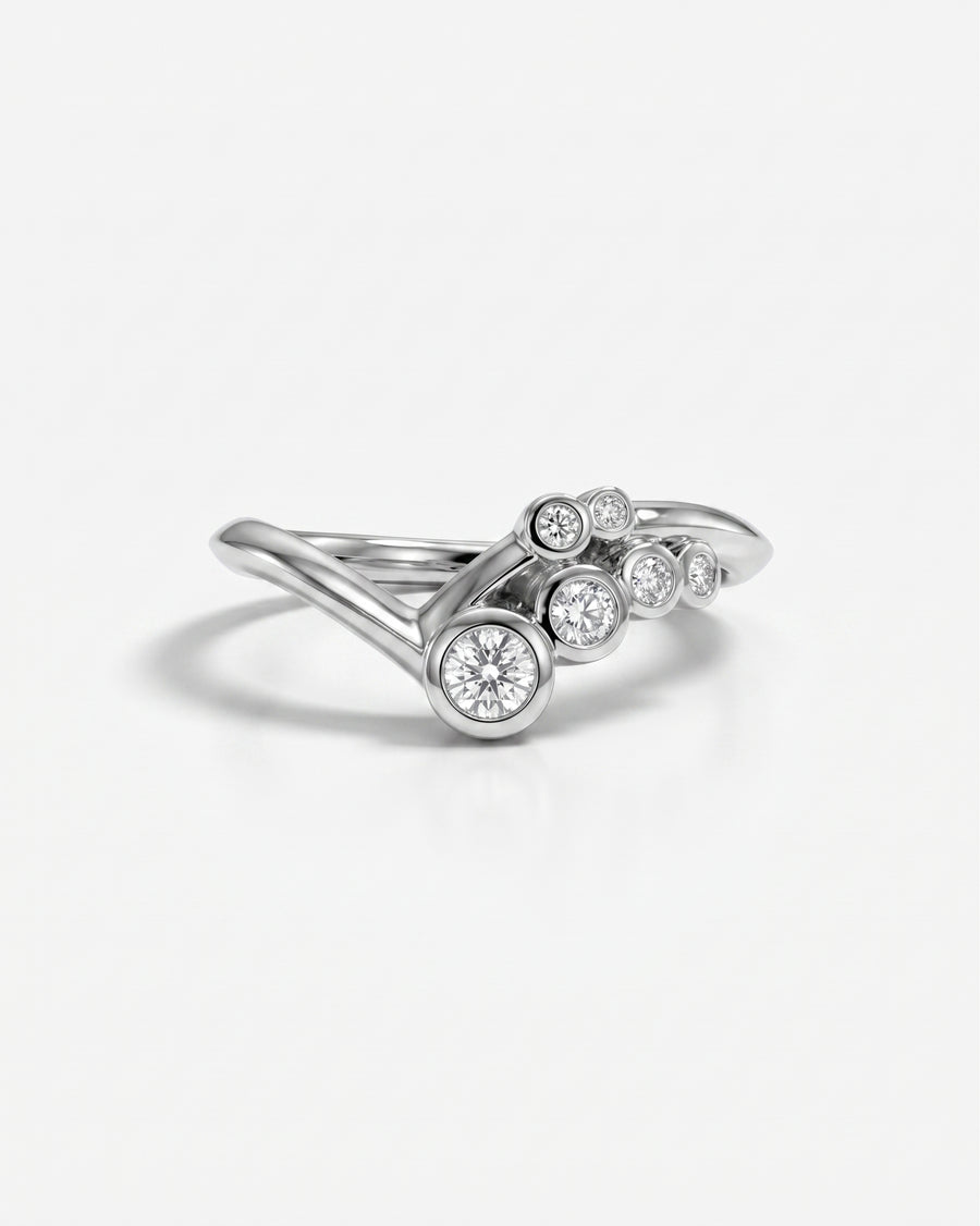 Silver ring with five bezel-set round diamonds in a curved, bubble-like design.