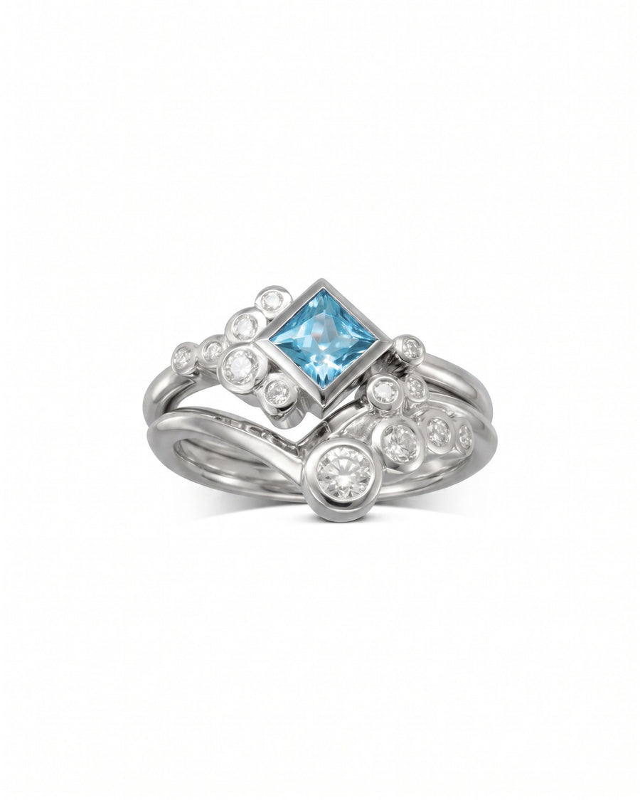 Silver ring set with a square aquamarine and round diamonds.