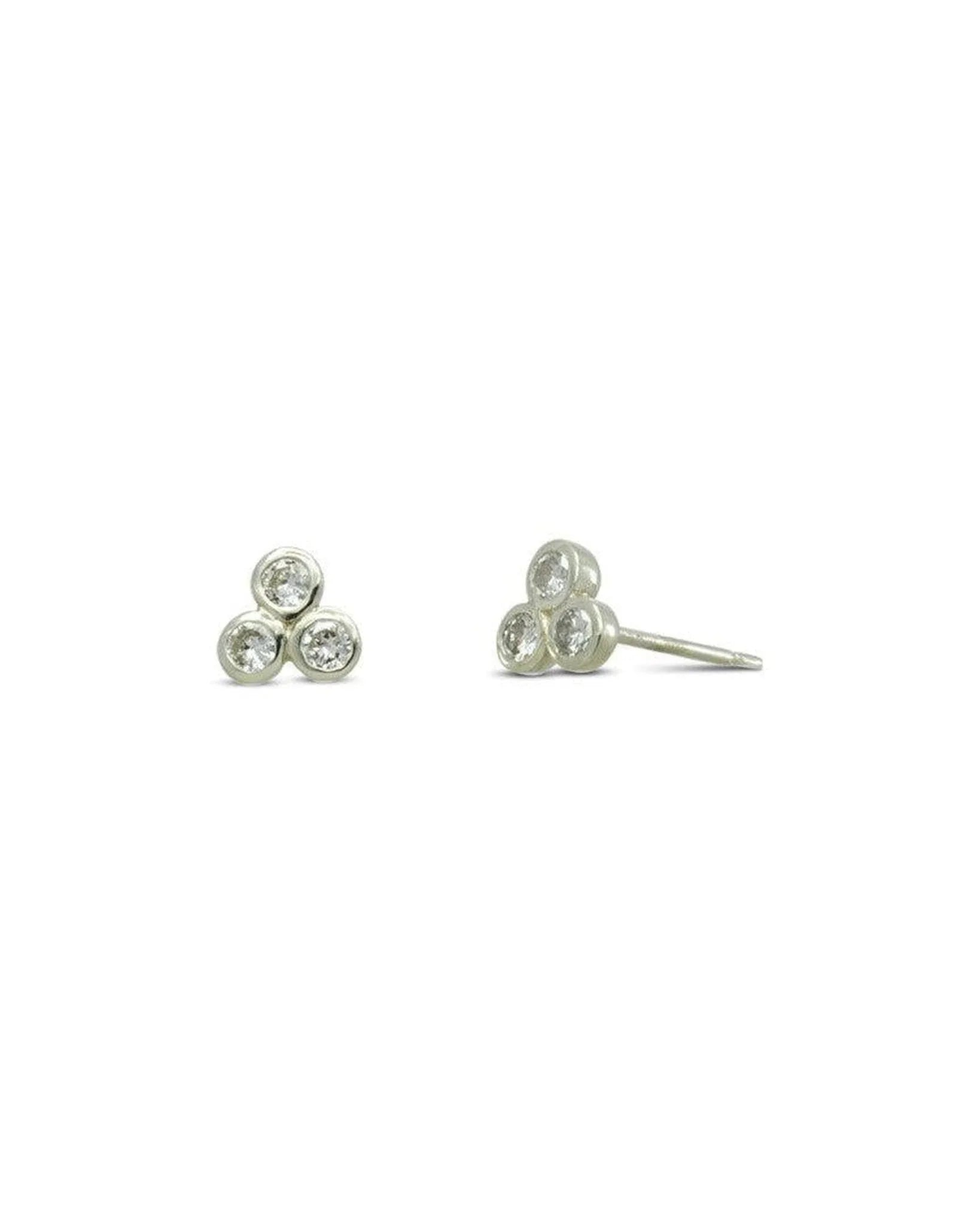 White gold stud earrings with three round diamonds in a trefoil design on white background