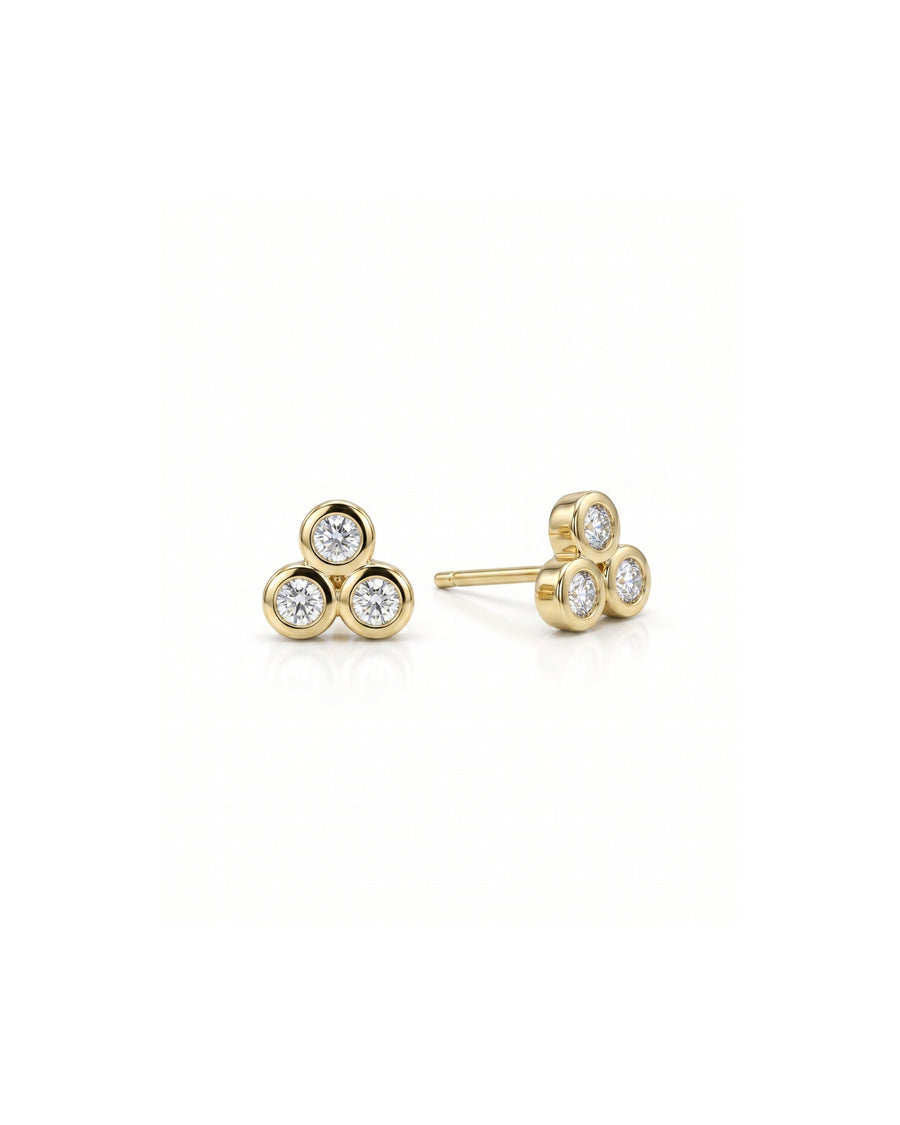 Gold trefoil stud earrings with three bezel-set diamonds.