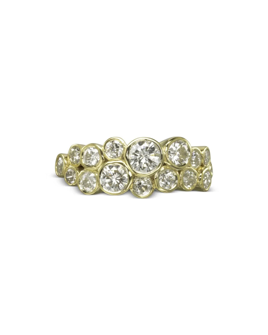 Gold ring with two rows of round, bezel-set diamonds in a bubble design.