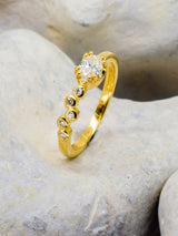 Bubbles and roman inspired ring on a stone background