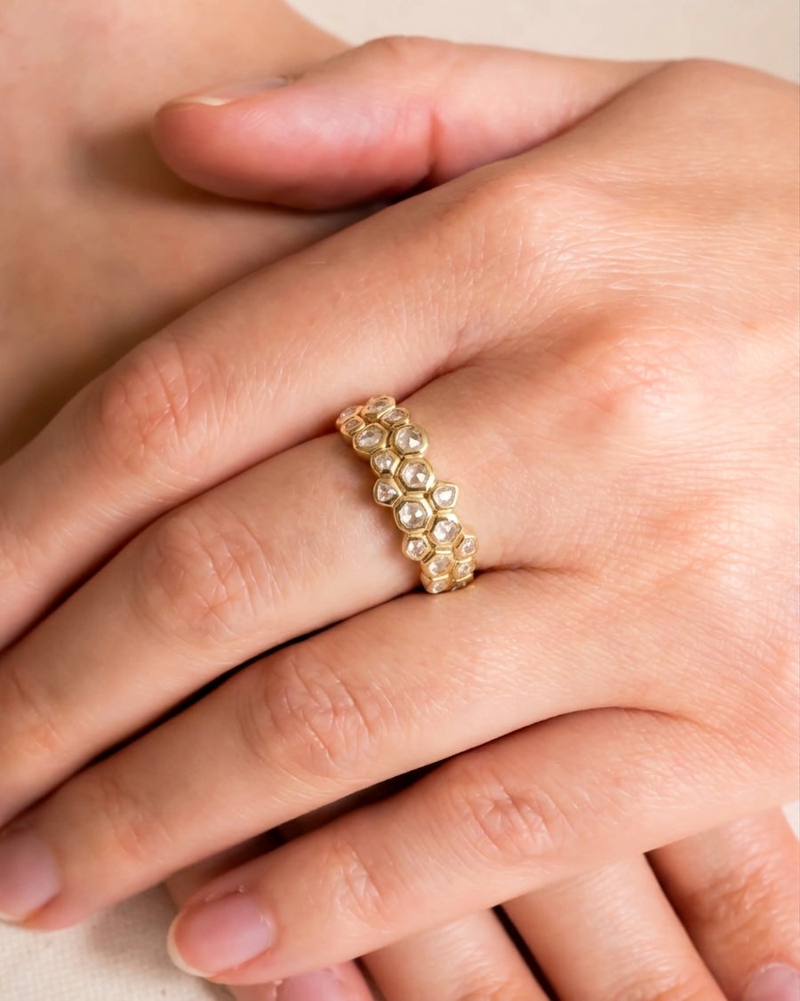 Gold eternity ring with carved small old cut diamonds.