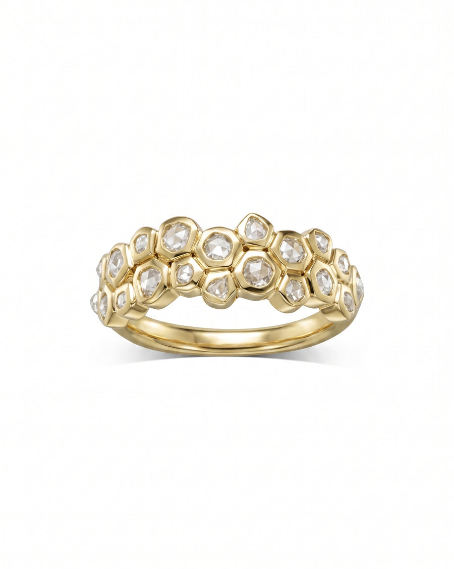 Gold eternity ring with carved small old cut diamonds in a honeycomb design.