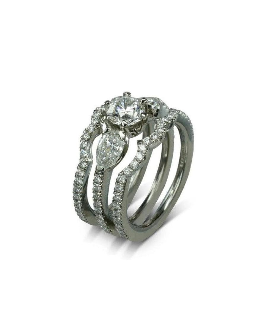 Diamond shaped white gold ring set with round and marquise diamonds on a white background
