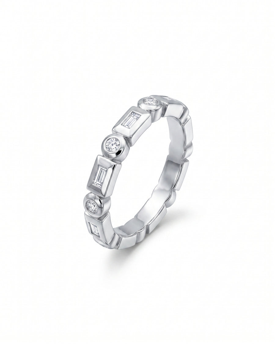 White gold full eternity ring with alternating baguette and round brilliant cut diamonds.