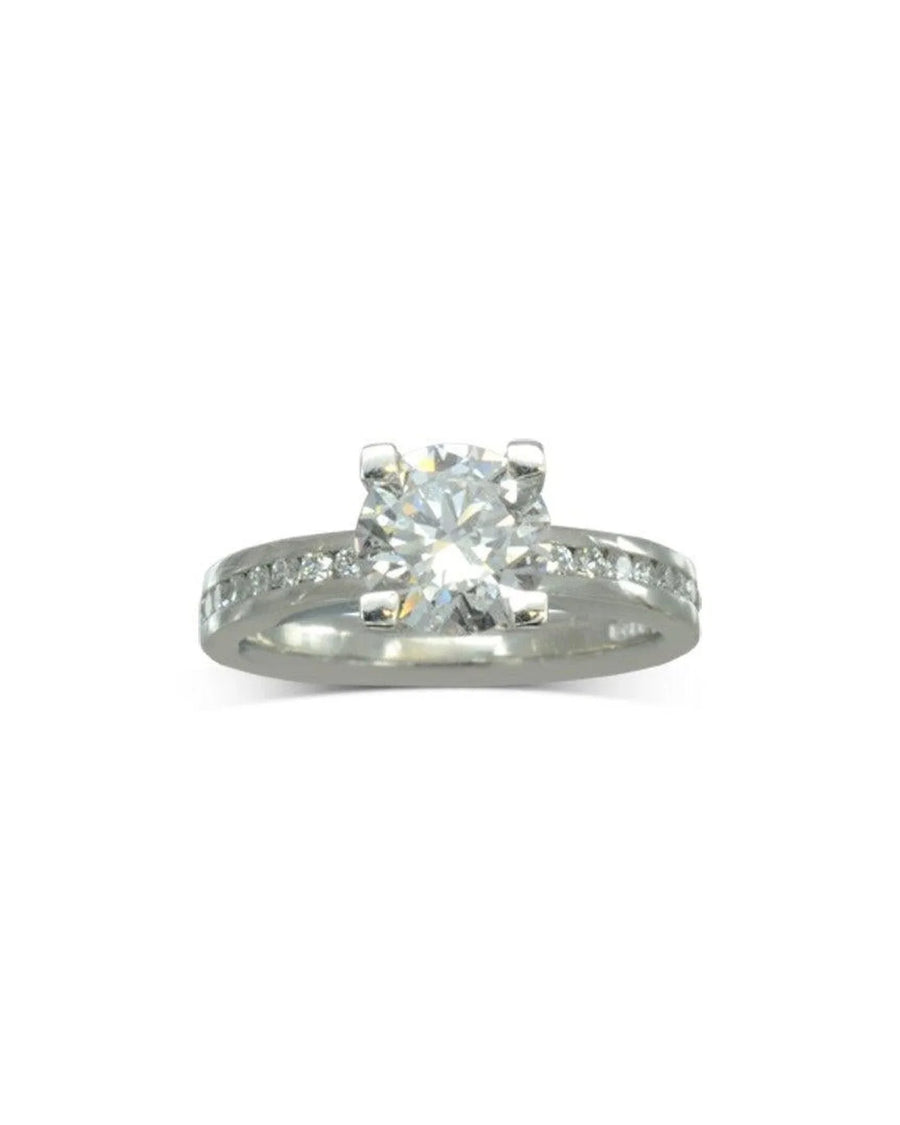 White gold channel set diamond engagement ring with a round center stone.