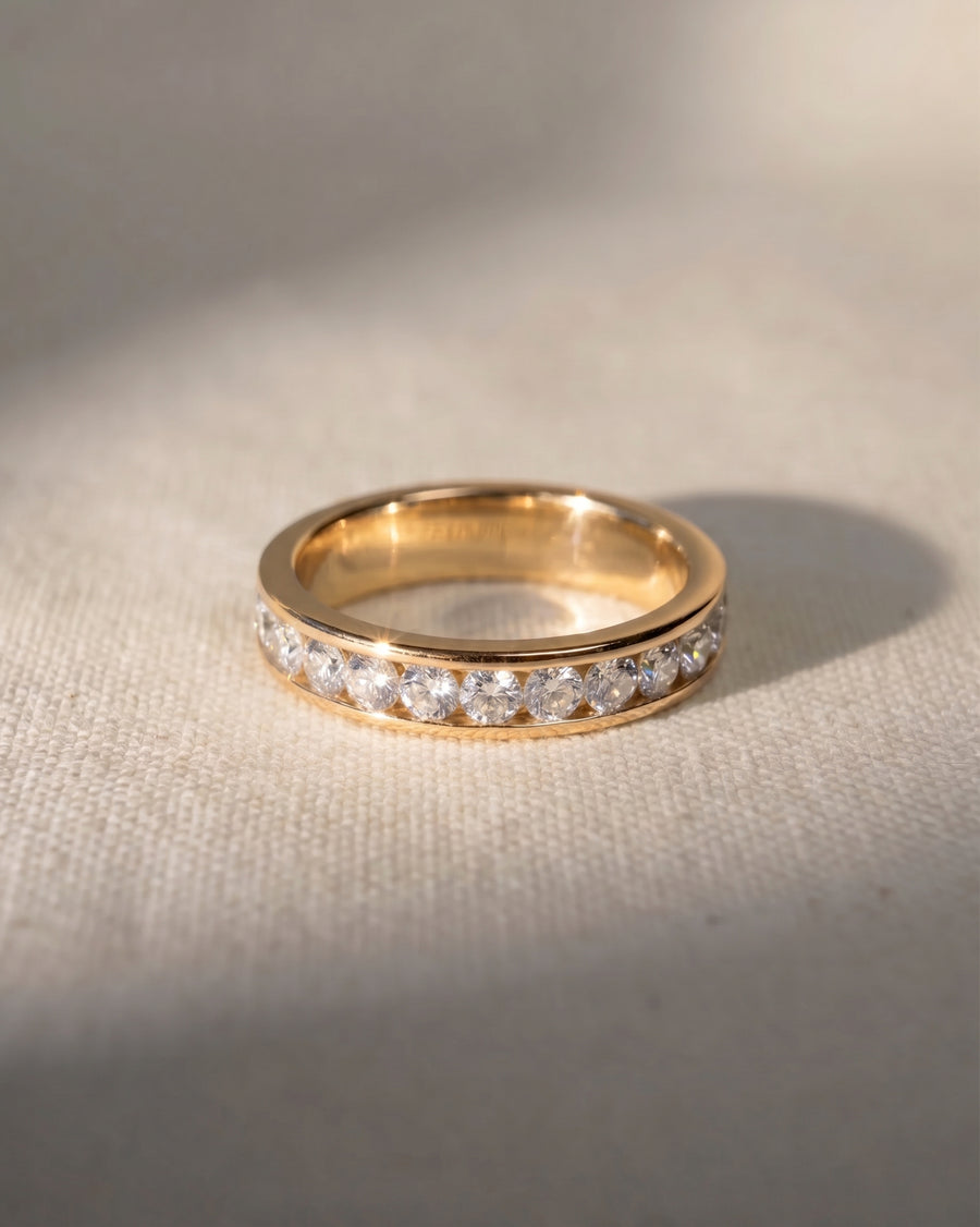 Gold channel set ring with round brilliant diamonds.