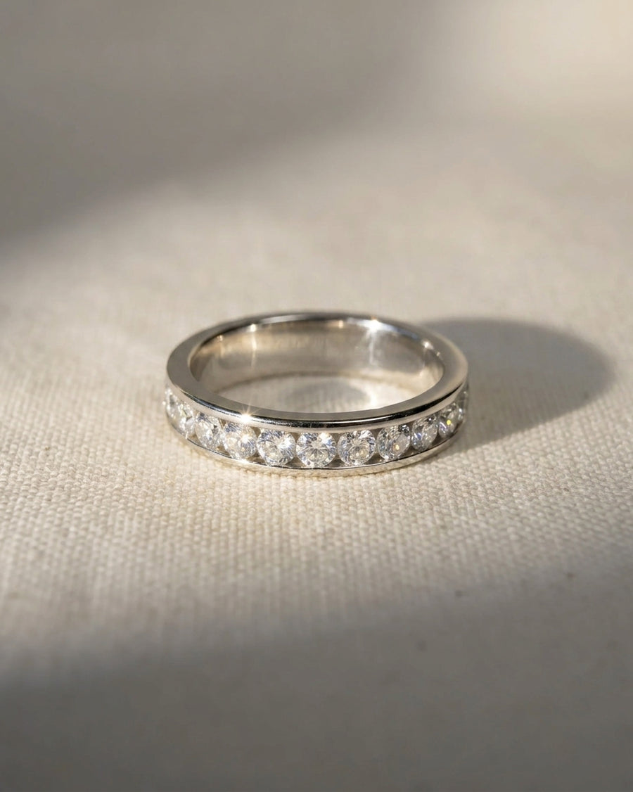 Platinum channel set round brilliant diamond ring.