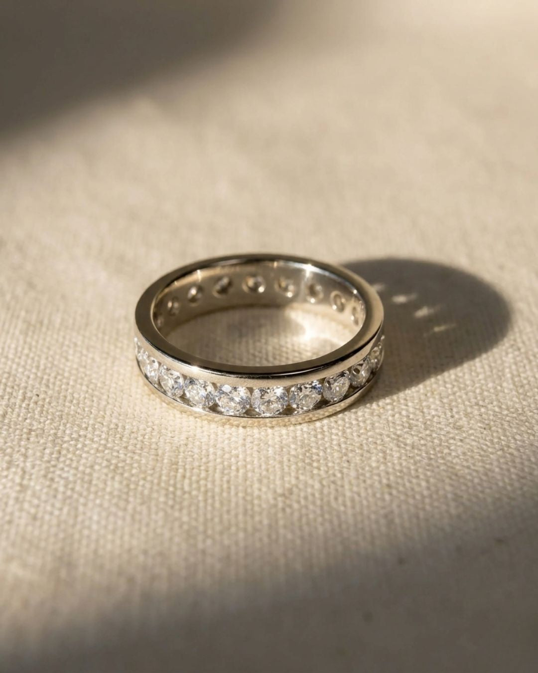 Platinum channel set ring with round brilliant cut diamonds.