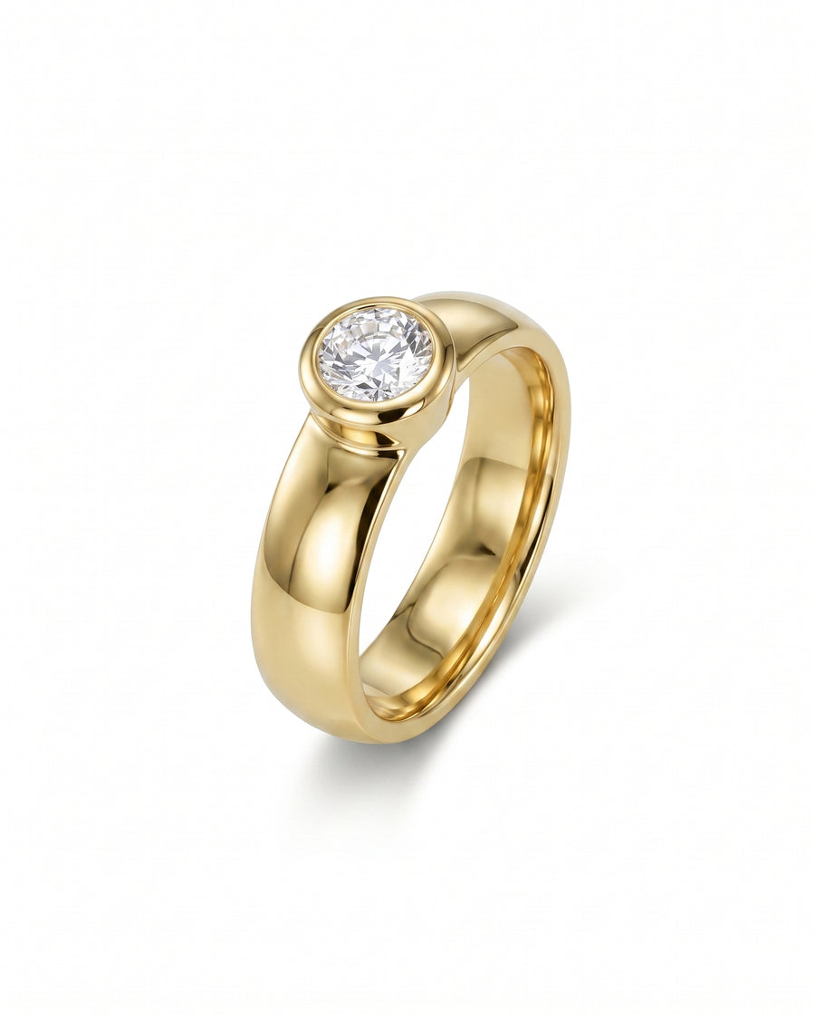 Gold chunky bezel brilliant cut diamond solitaire engagement ring.