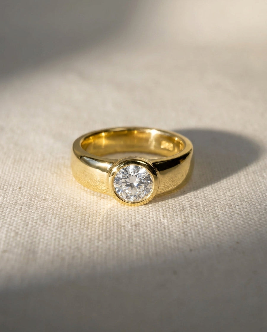 18ct yellow gold chunky bezel solitaire ring with a brilliant cut diamond.