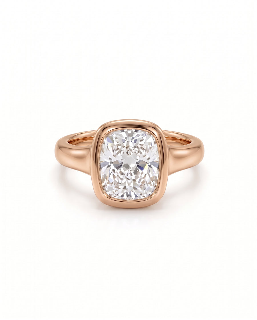 Chunky cushion cut diamond engagement ring set in a polished rose gold bezel setting.