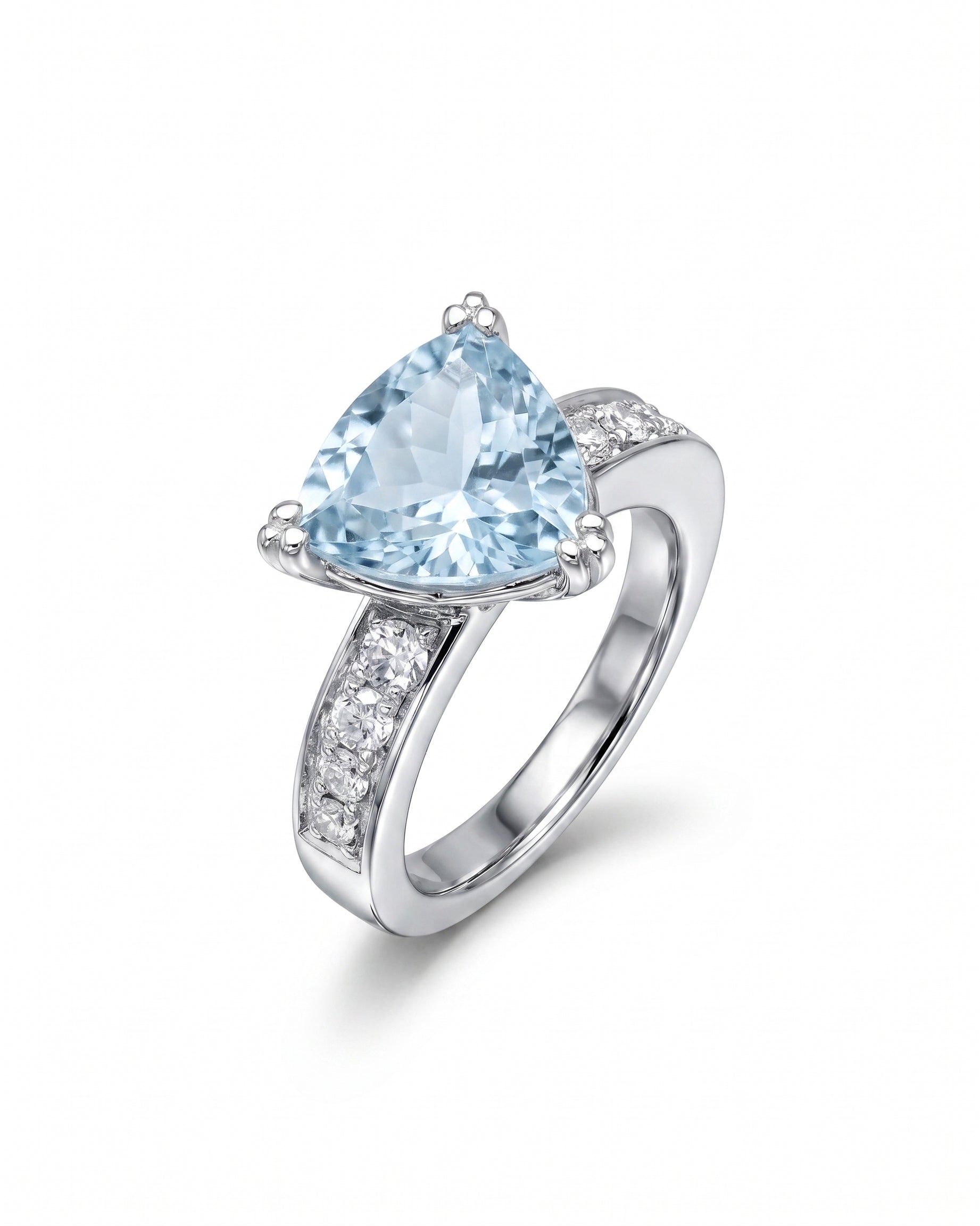 Silver ring with a large trillion-cut blue gemstone and small clear side stones.
