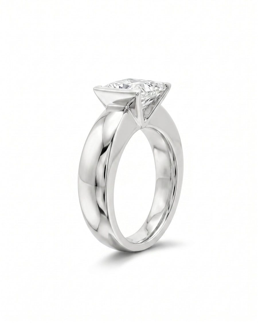 White gold chunky V set ring with a princess cut diamond.