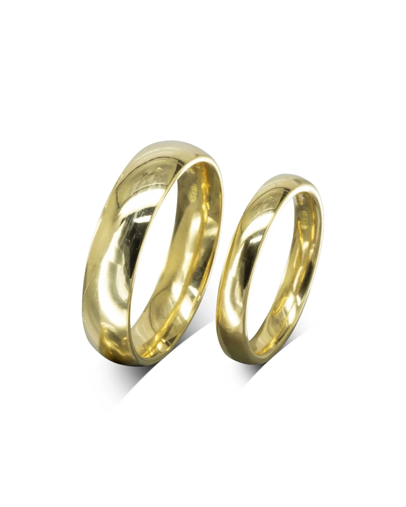 Pair of classic yellow gold wedding rings with a polished finish on white background