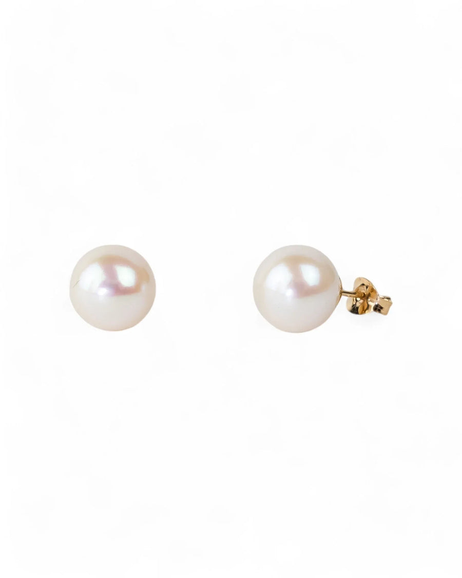 Gold stud earrings with classic round white pearls.