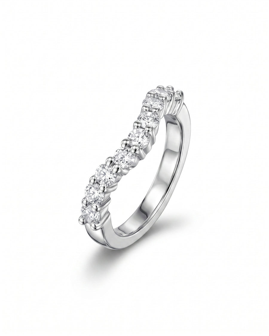 Silver wedding ring with a curved band of round cut diamonds.