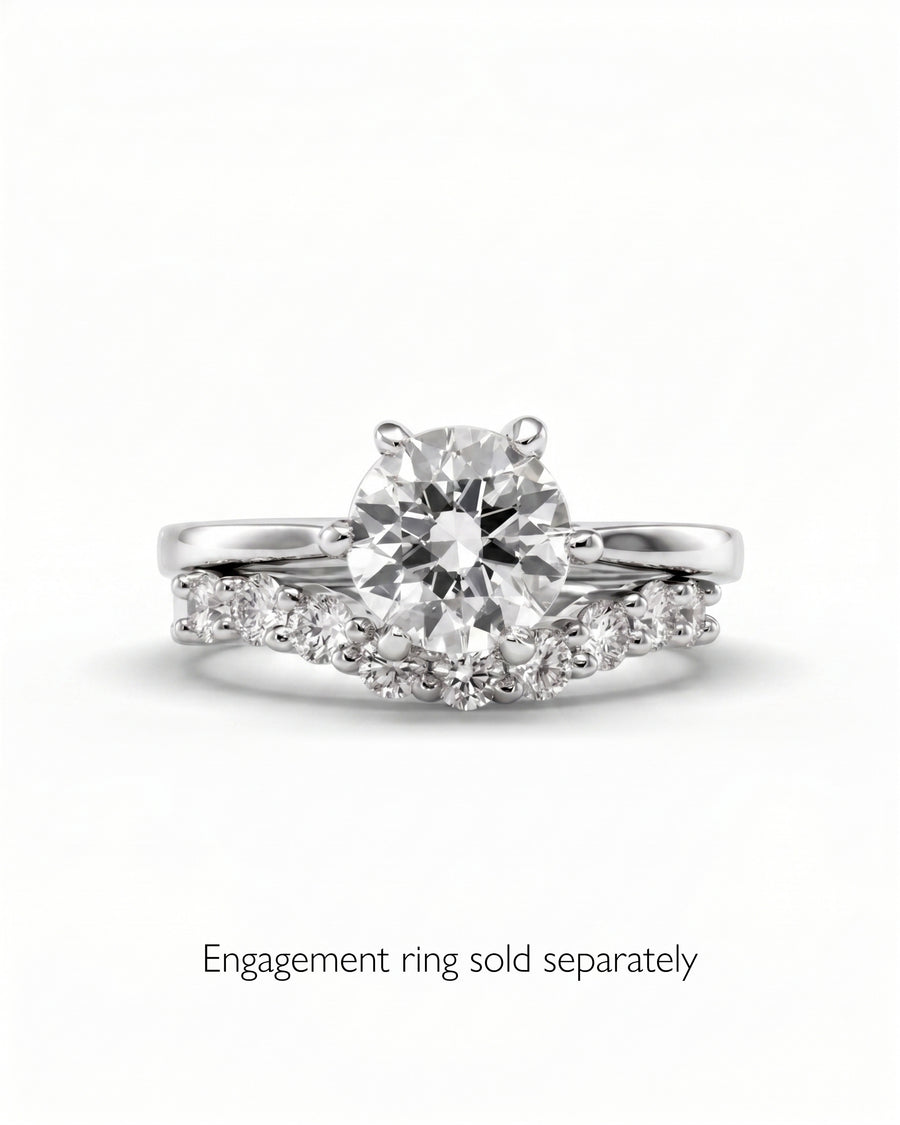 Silver claw round cut diamond wedding ring with curved diamond band.